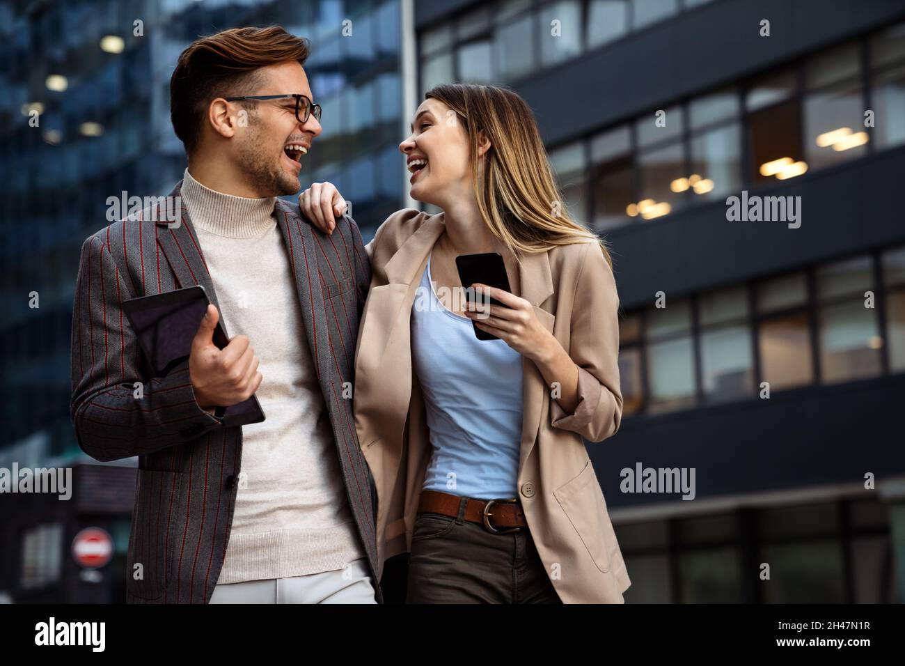 Portrait of successful business people working, talking together in urban background. Stock Photo