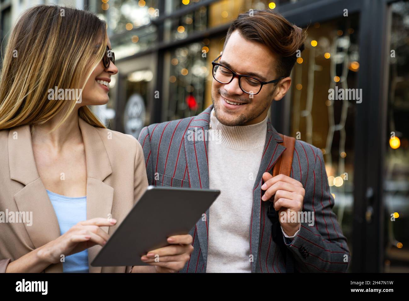 Happy successful business couple having fun, working together outdoors