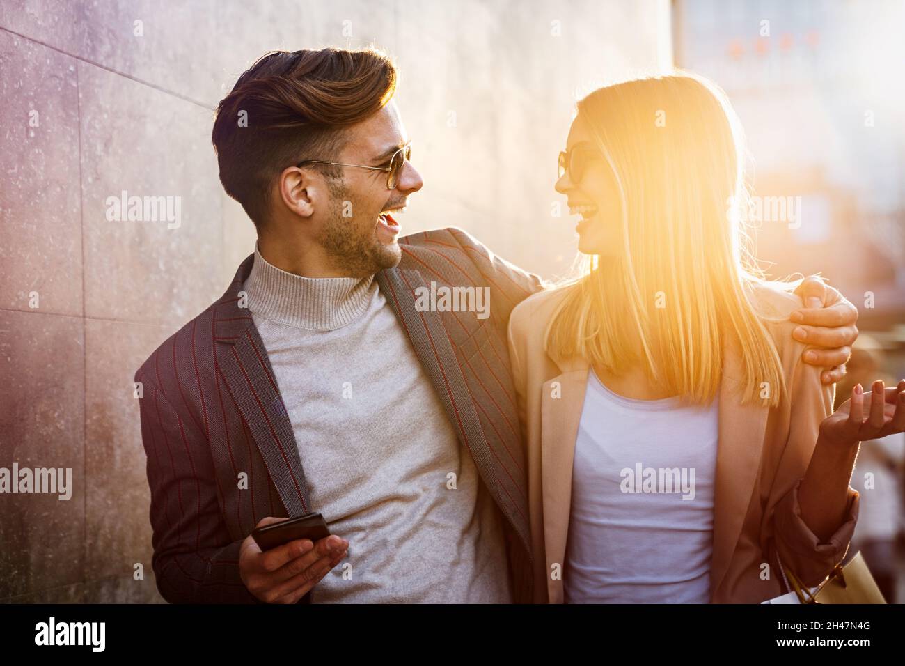 Happy smiling couple having fun together in city. People travel business happiness concept Stock Photo