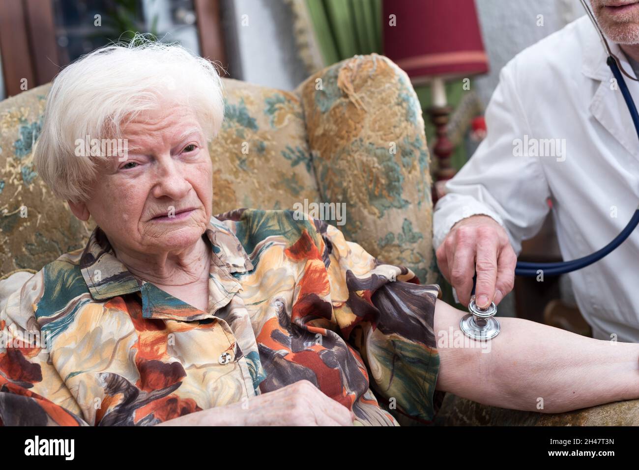 Doctor measuring blood pressure of senior woman Stock Photo - Alamy