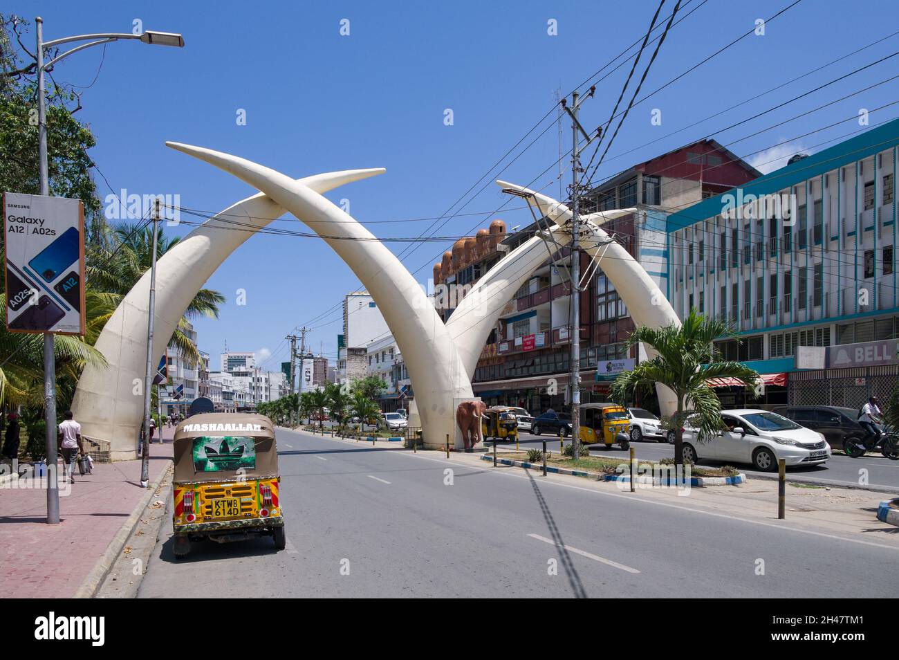 Large aluminium elephant tusks, Pembe Za Ndovu, form an arch over Moi avenue, Mombasa, Kenya Stock Photo