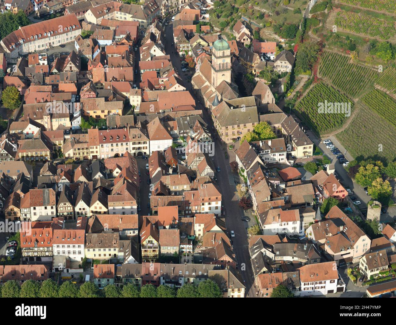 AERIAL VIEW. Picturesque town at the eastern foothills of the Vosges Mountains. Kaysersberg-Vignoble, Alsace, Grand Est, France. Stock Photo