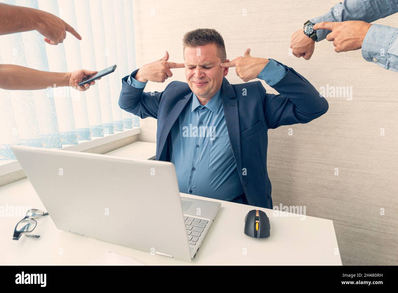 Businessman in his office making suicide gesture. office worker tired of work is overworked and does not want to work. concept of overstrain during op Stock Photo