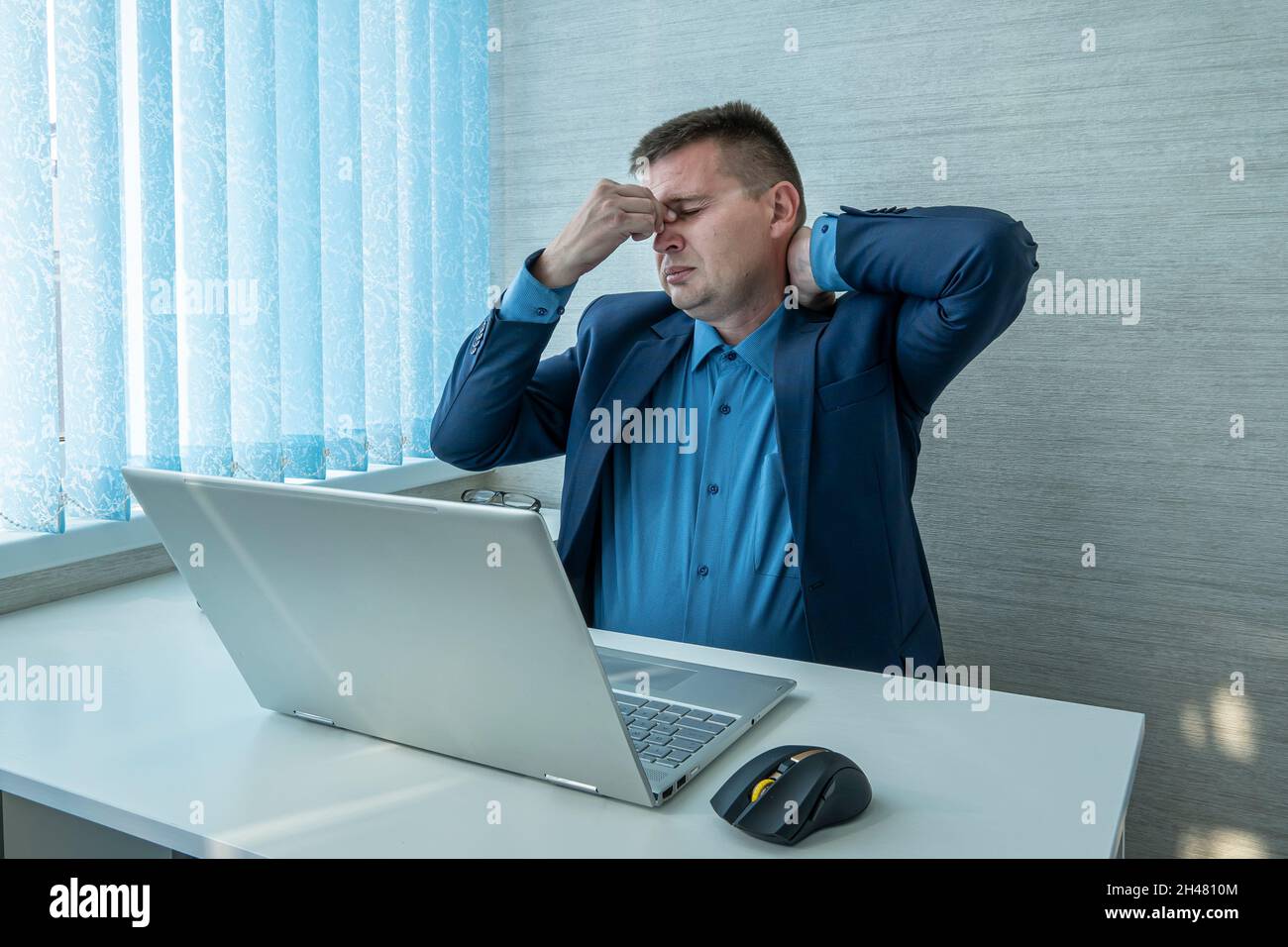 portrait of sad tired young man covering eyes full of pain and stress having fatigue. Stressful handsome Caucasian man trying to concentrate, find sol Stock Photo