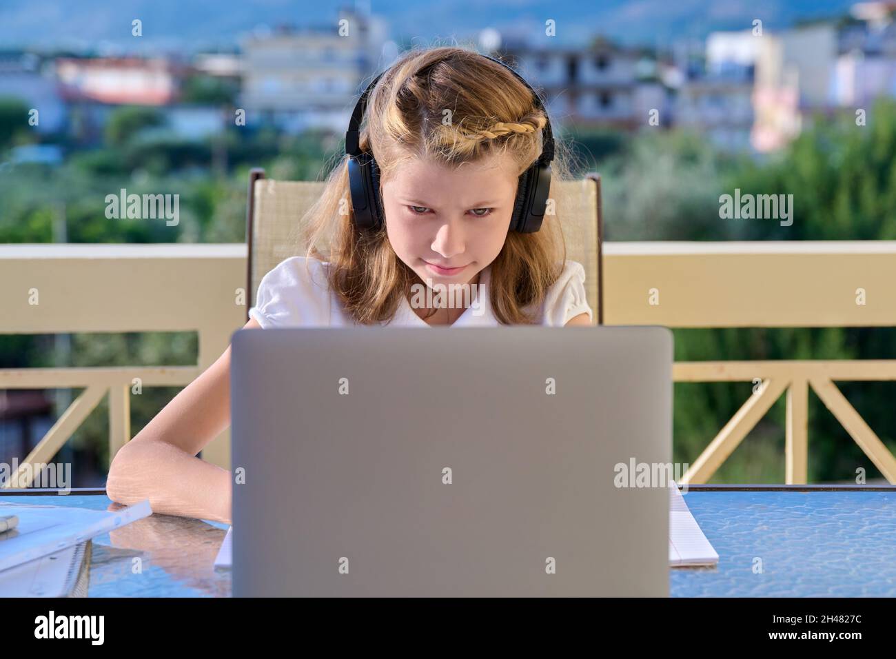 Girl child 10, 11 years old studying at home online Stock Photo - Alamy