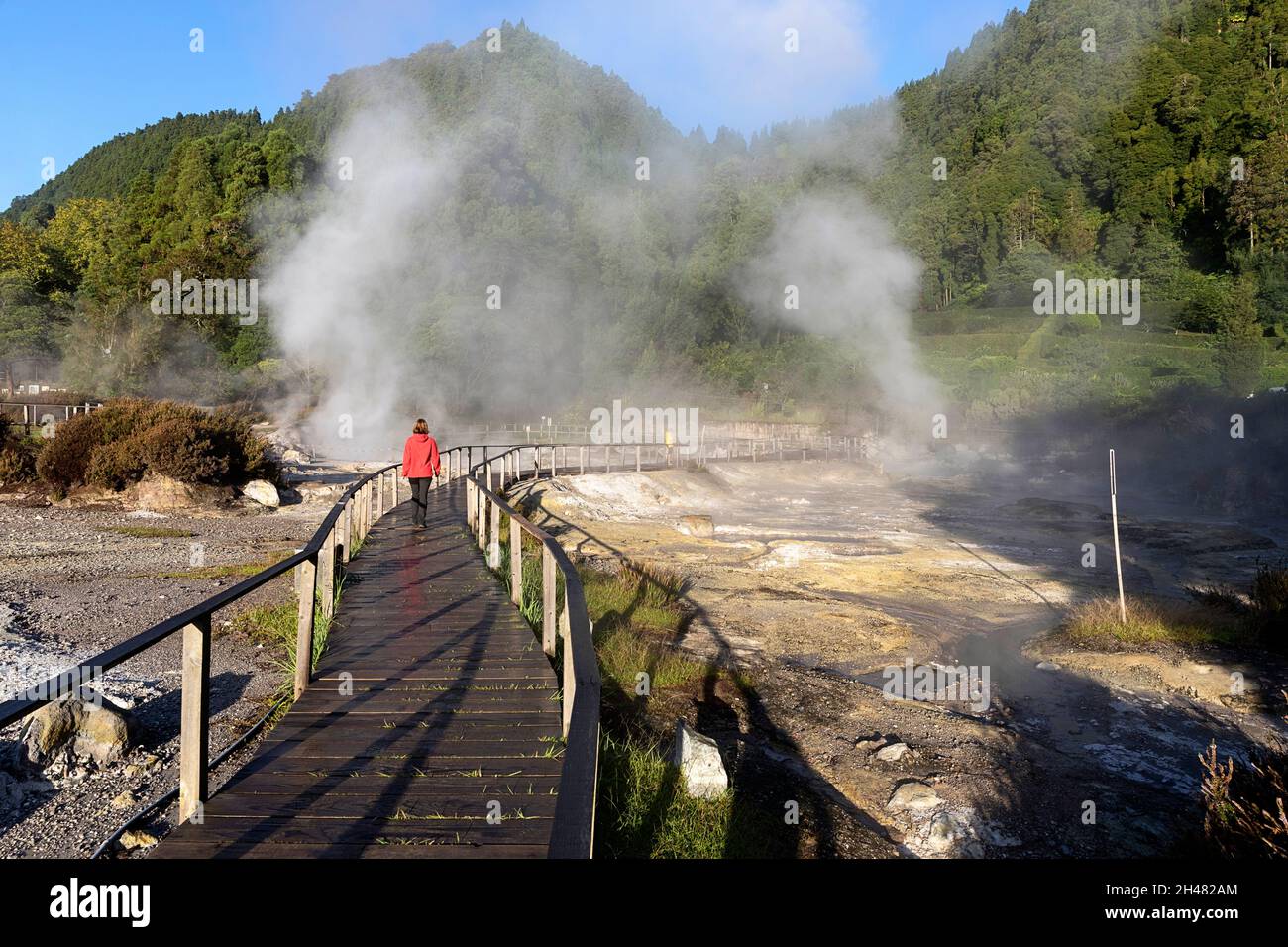 Lagoa das Furnas e Fumarolas, woman walking on a site of bubbling hot