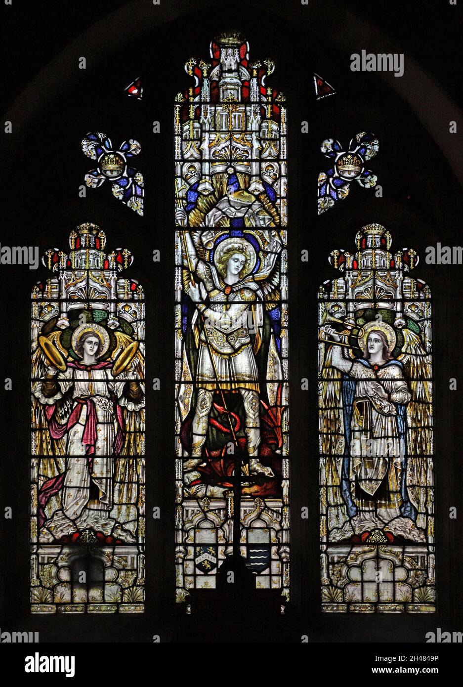 A stained glass window by Herbert Davis depicting Archangel Michael slaying the dragon, St Michael & All Angels Church, Fringford, Oxfordshire Stock Photo