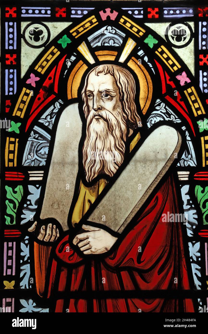 A stained glass window by Michael O'Connor depicting Moses, St Michael & All Angels Church, Fringford, Oxfordshire Stock Photo