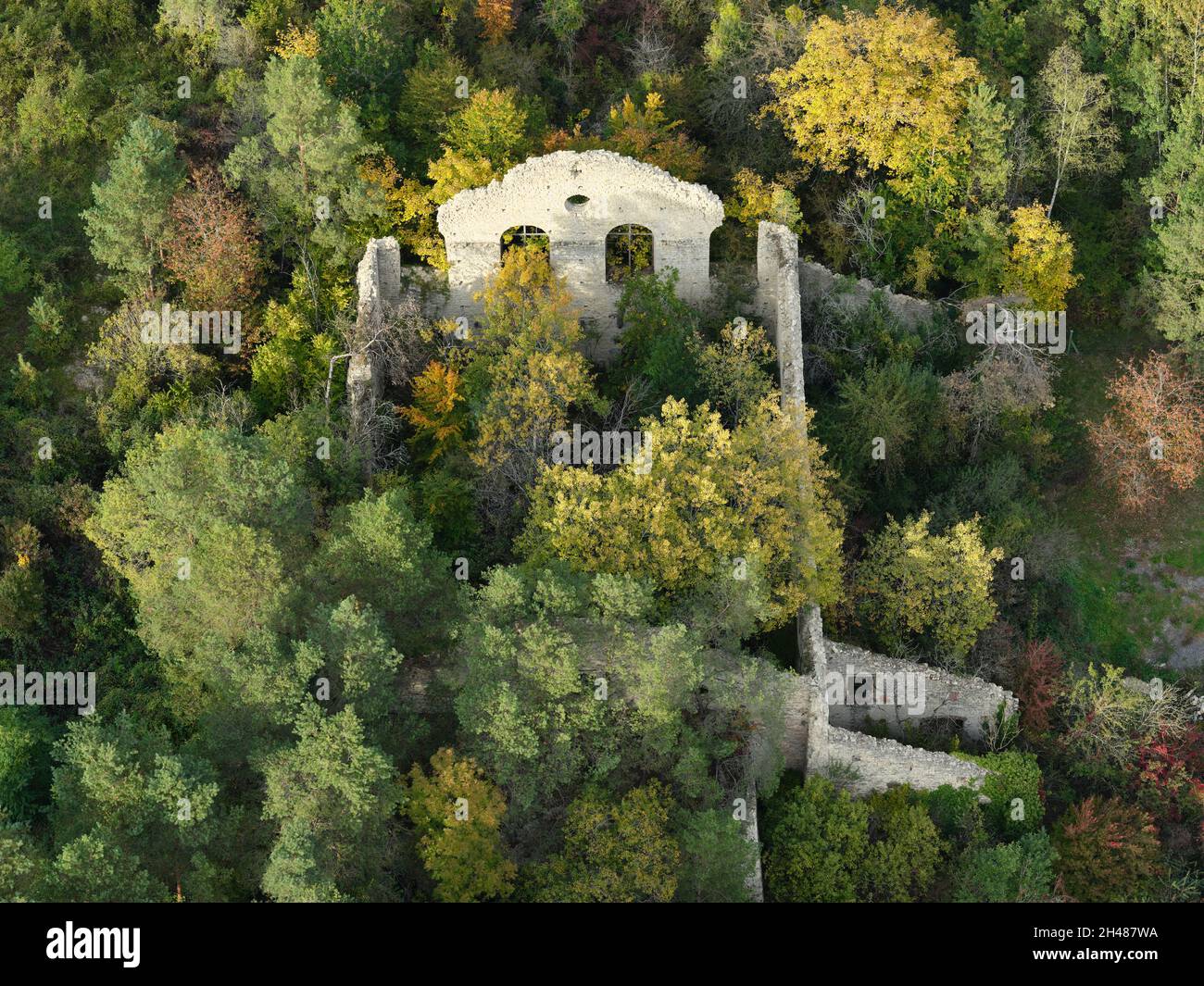 AERIAL VIEW. Building in ruins being overgrown by vegetation in the fall. Ville-sous-la-Ferté, Aube, Grand Est, France. Stock Photo
