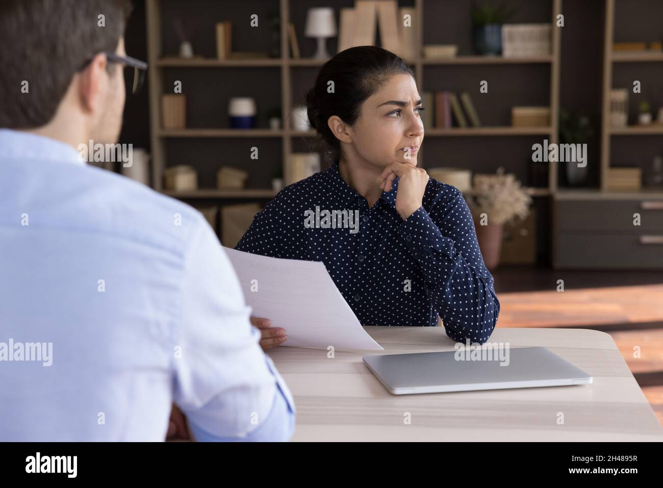 Unhappy young Indian candidate dissatisfied with job offer. Stock Photo