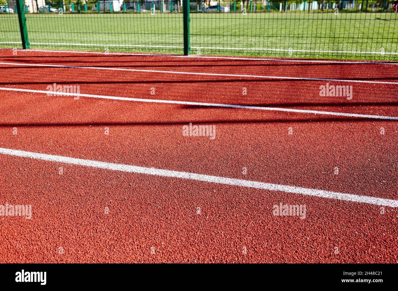 Red treadmill on sport field. Running track on the stadium Stock Photo Alamy