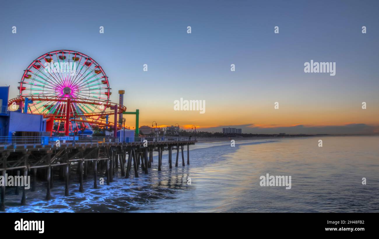 Sunrise at the pier Santa Monica, California The Ferris wheel in the background Stock Photo