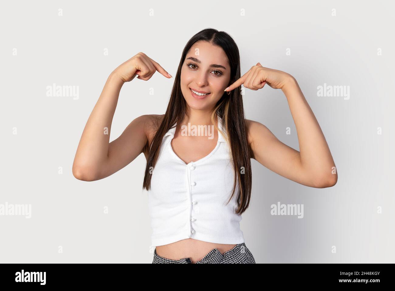 Young brunette woman is pointing her self. A gesture for using as marketing. High quality photo Stock Photo