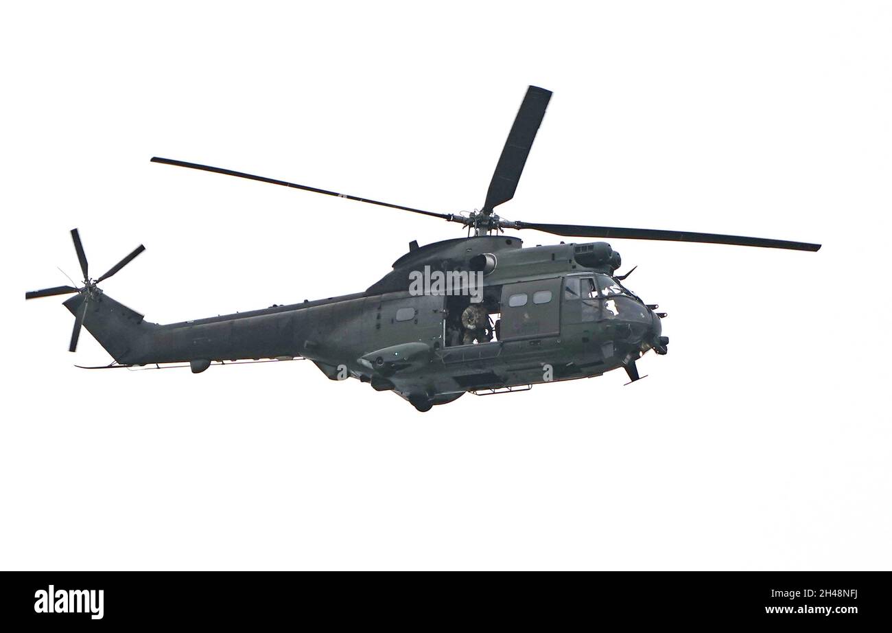 A military helicopter follows the motorcade of U.S. President Joe Biden as it heads along the M8 motorway towards the Cop26 summit in Glasgow after he arrived at Edinburgh Airport. Picture date: Monday November 1, 2021. Stock Photo