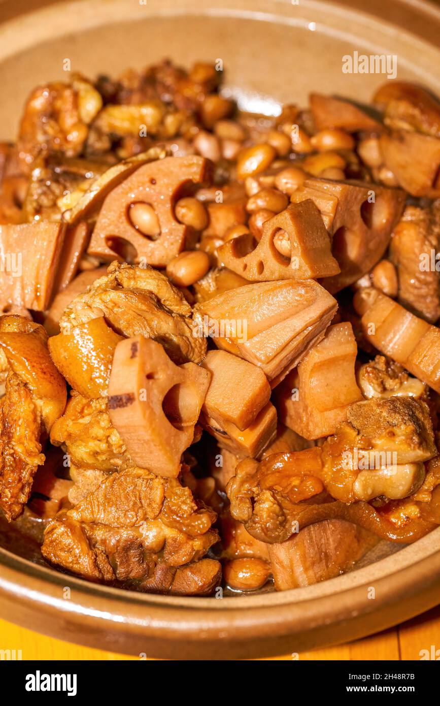 A delicious Chinese dish, braised pork feet with lotus root Stock Photo