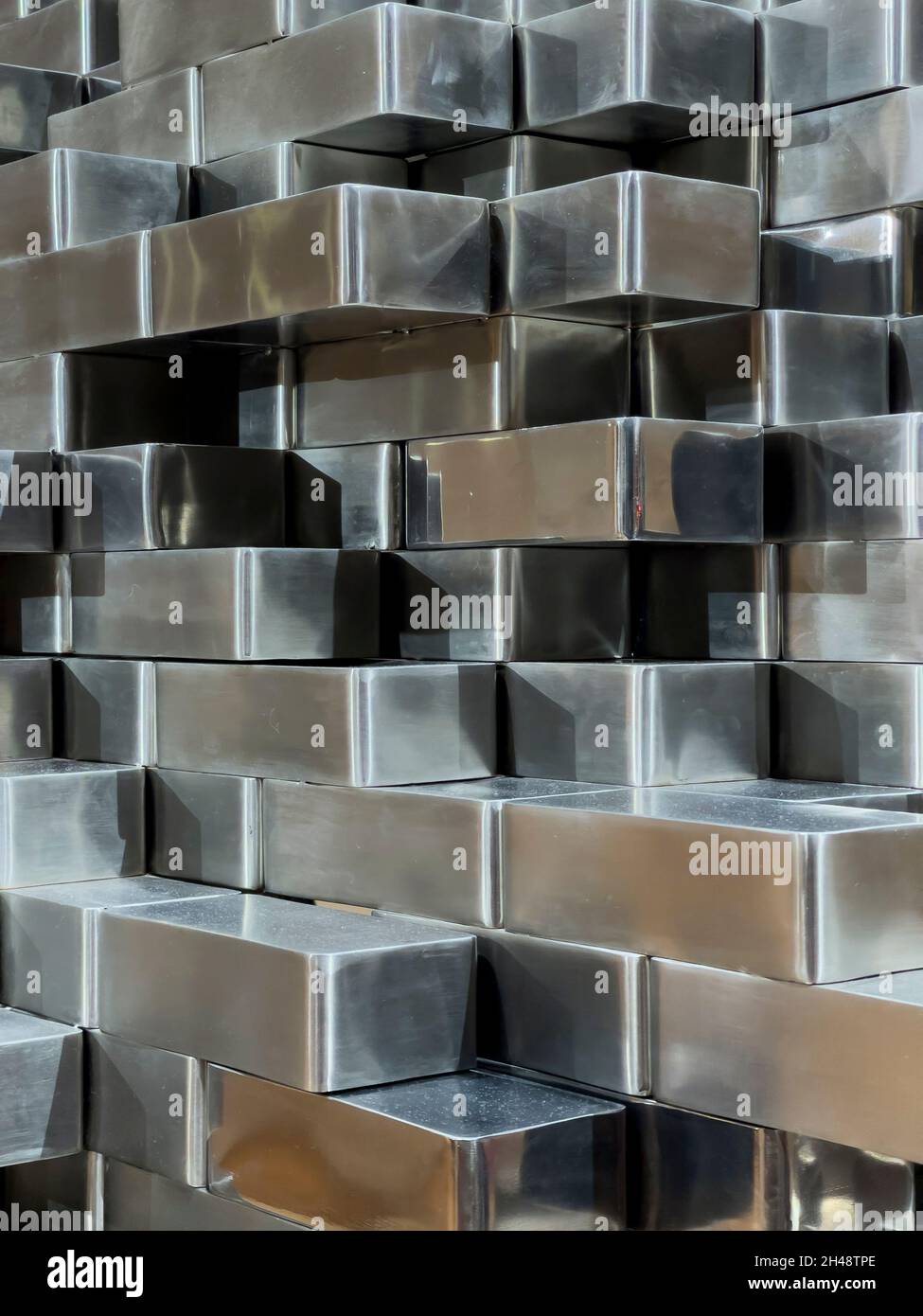 Pile of faceted steel blocks background - full frame close-up. Stock Photo