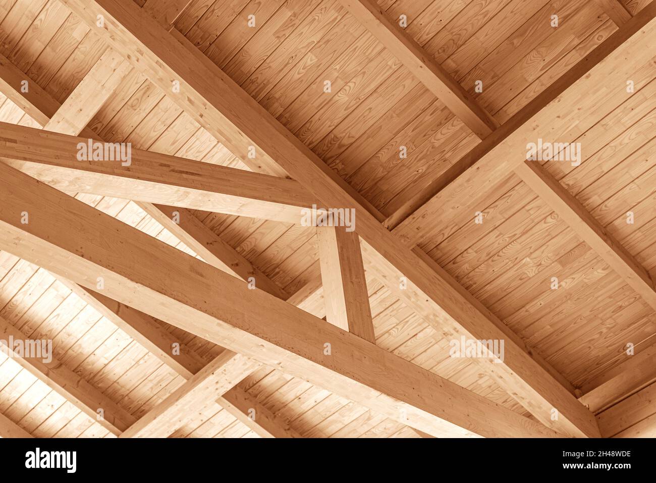 Wooden roof construction. Overlapping a wooden house. Stock Photo