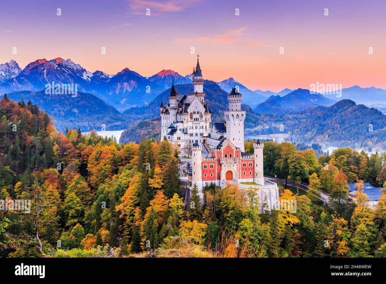 Germany, Neuschwanstein Castle. View of the castle and the Bavarian Alps at sunrise during fall season. Stock Photo