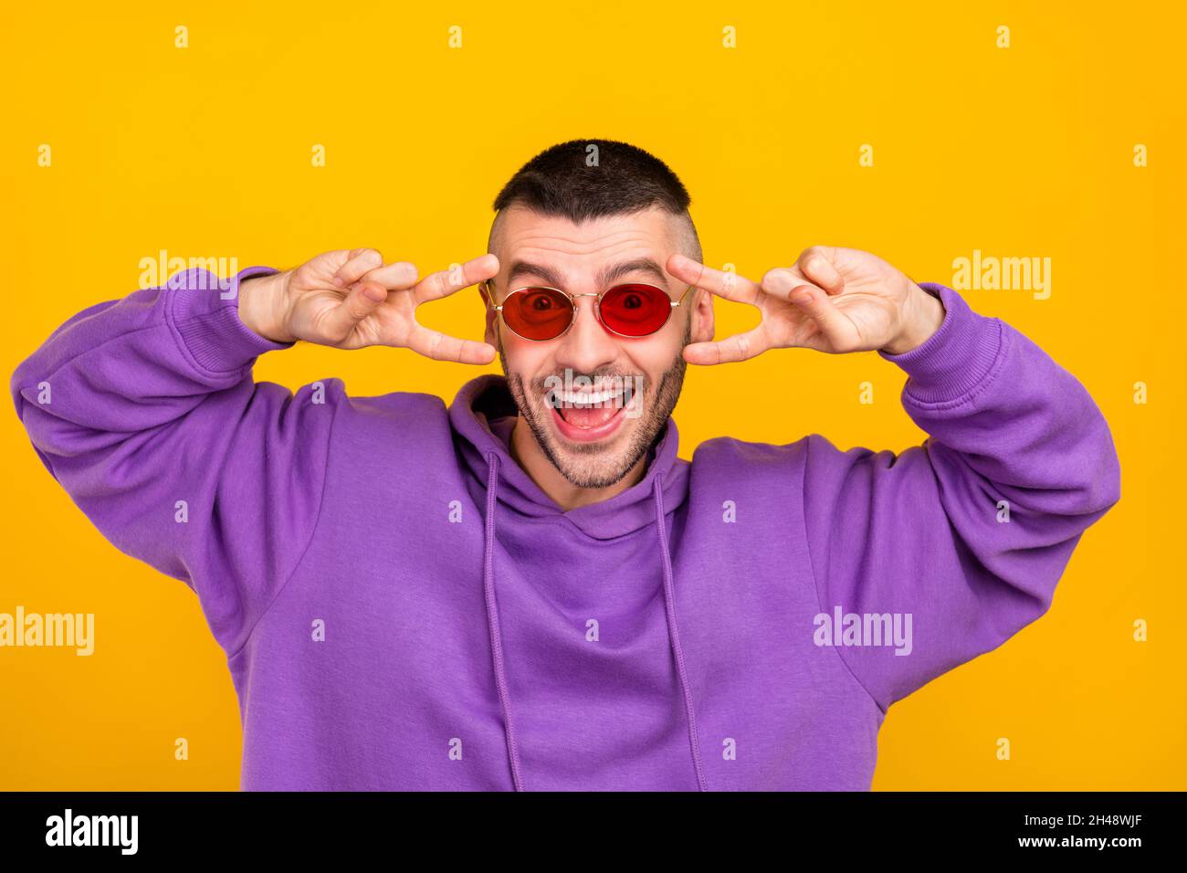 Portrait of attractive funny cheerful guy showing double vsign good