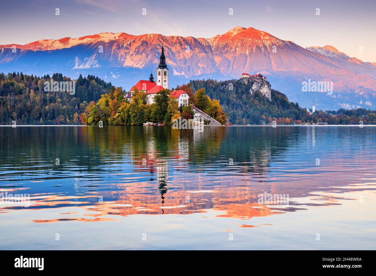 Lake Bled, Slovenia. Sunset at Lake Bled with famous Bled Island and historic Bled Castle in the background. Stock Photo