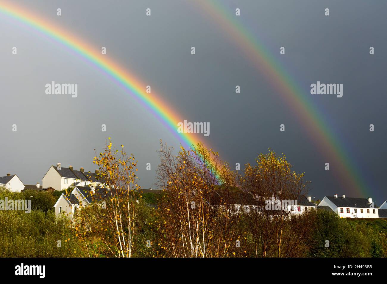 Double rainbow over social housing in Ardara, County Donegal, Ireland Stock Photo