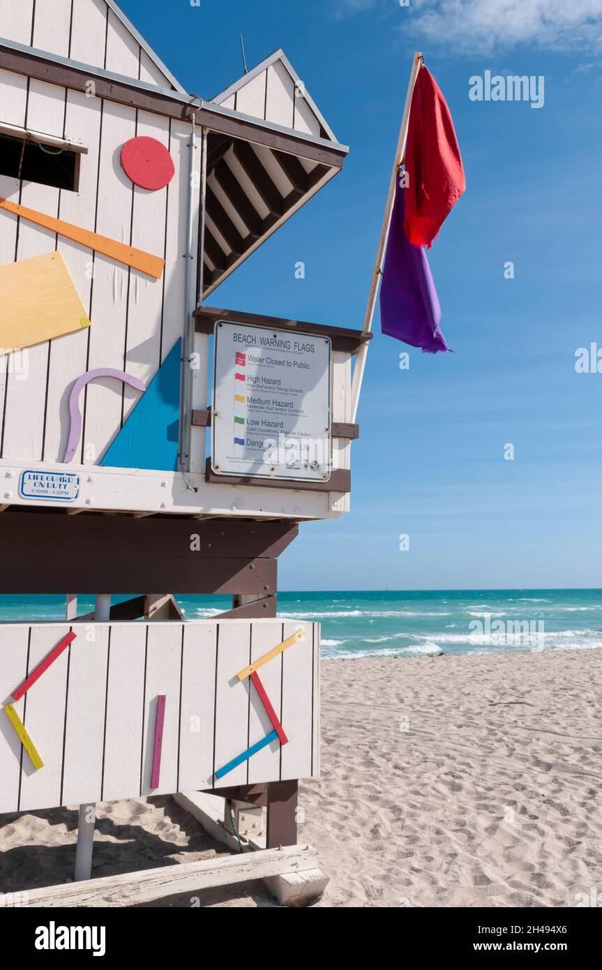 A wooden lifeguard station on Miami Beach with warning flags on the beach, Florida, USA Stock Photo