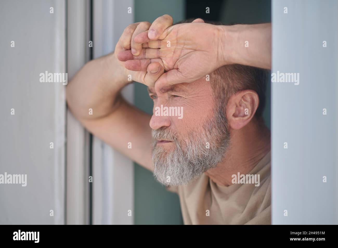 Serious pensive mature man looking at something Stock Photo