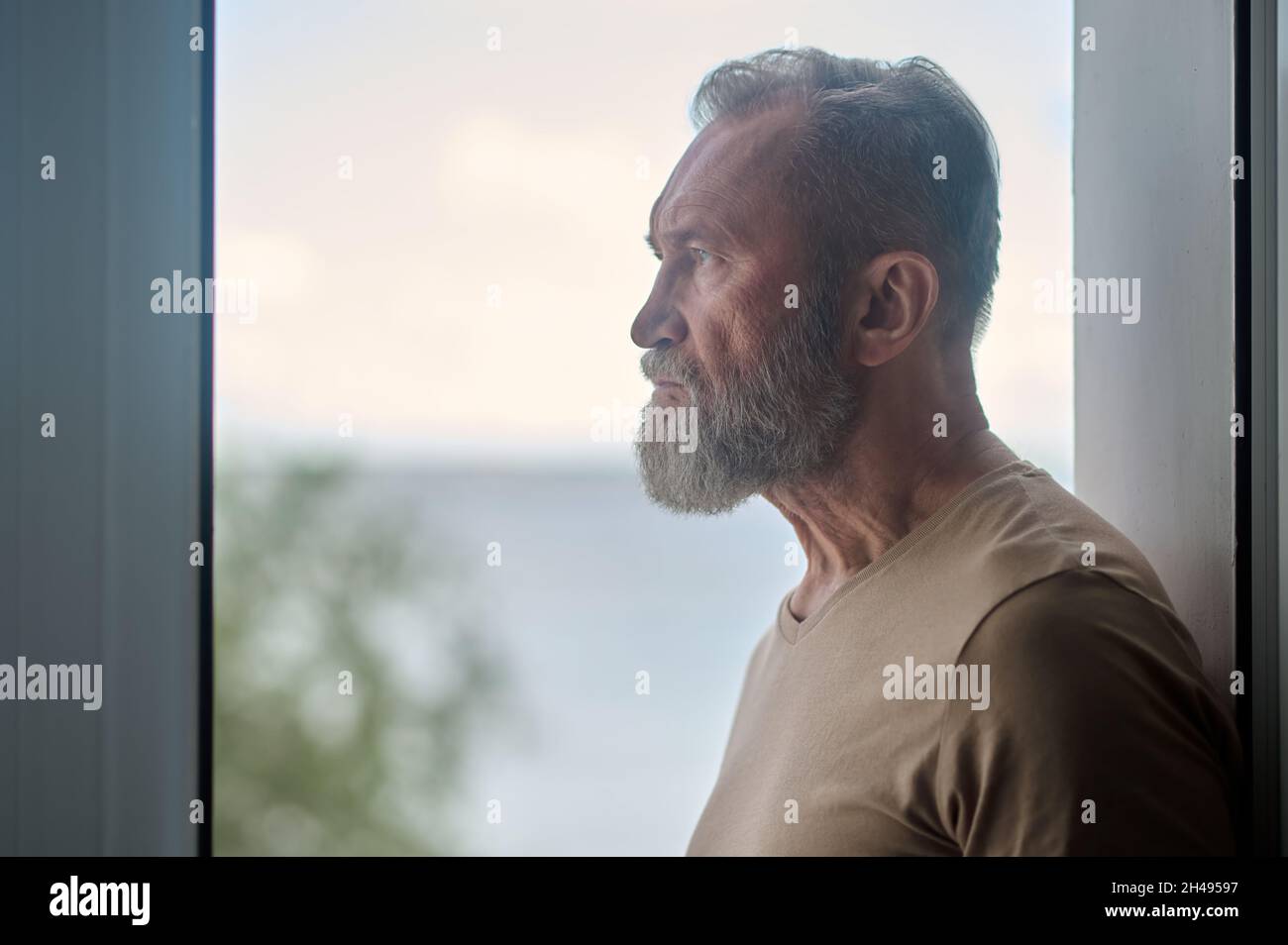 Thoughtful mature man looking into the distance Stock Photo