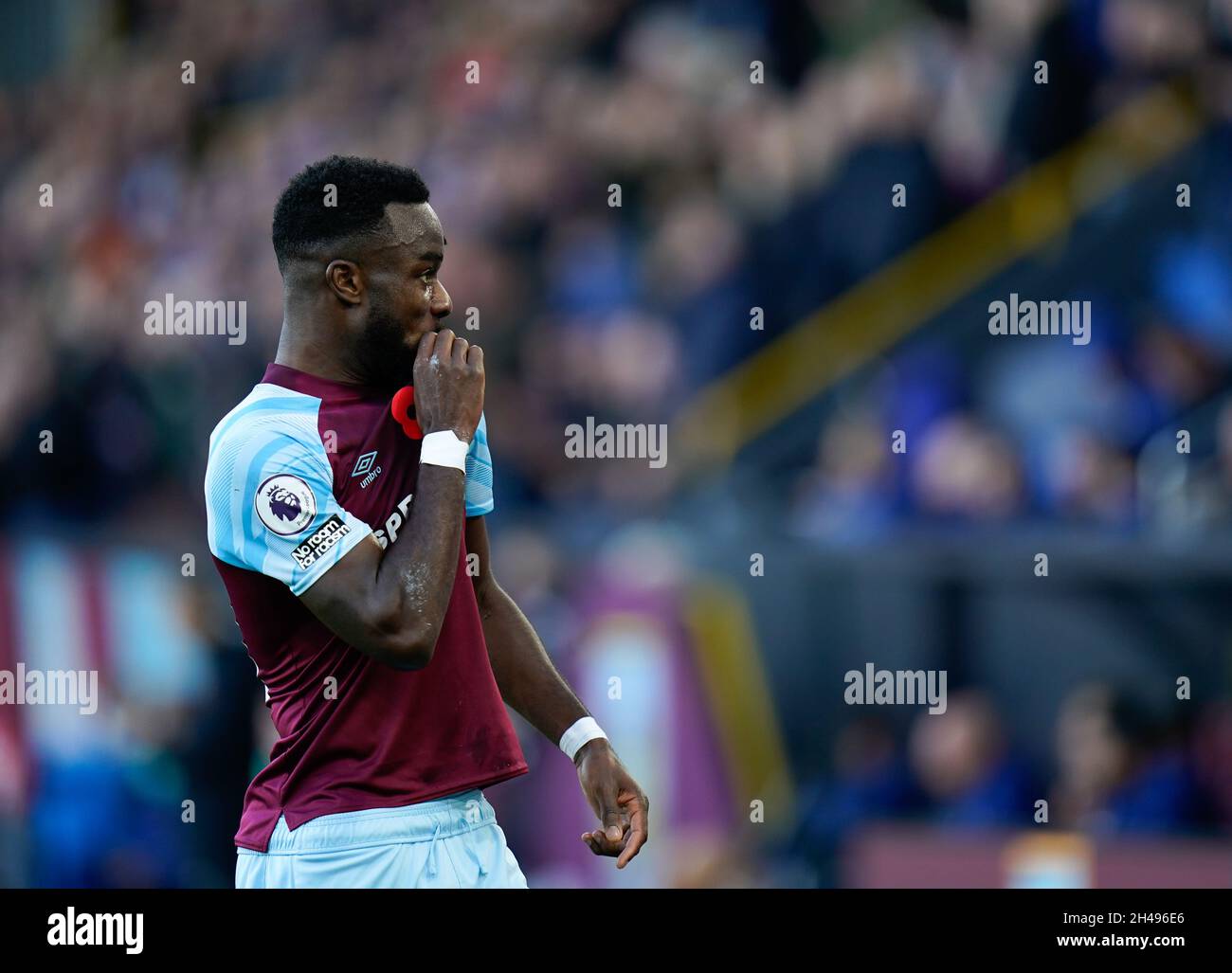 Burnley's goal scorer Maxwell kisses. The club badge after