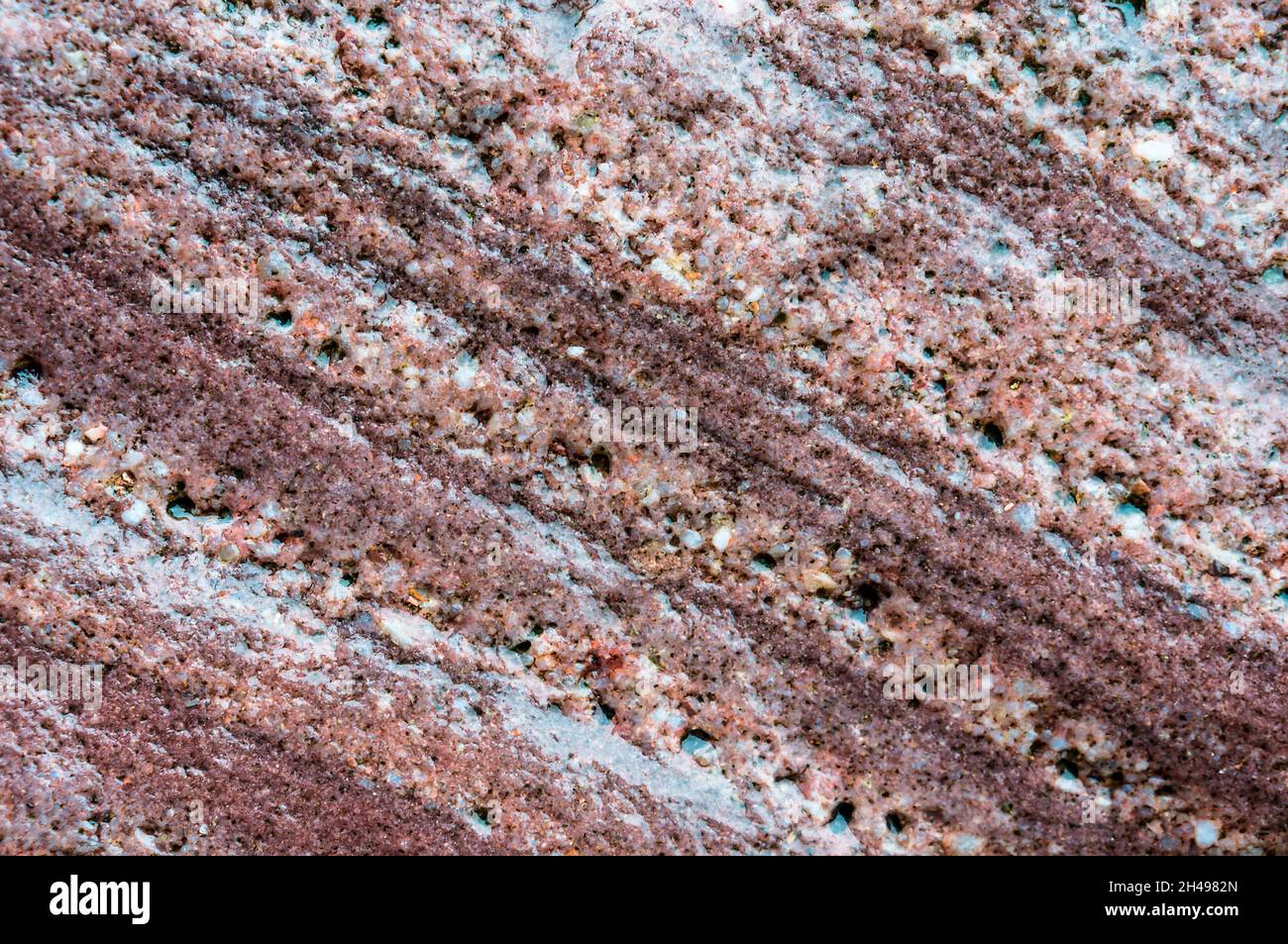 Natural stone background. Sea stone texture. Panel texture. Spots gray red background. Background fill. Stock Photo