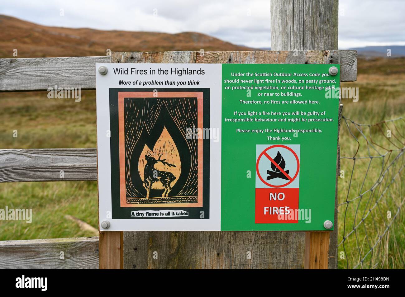 Sign warning against wild fires in the Scottish Highlands and stating that no fires are allowed here. On wooden gate with blurred moorland background. Stock Photo