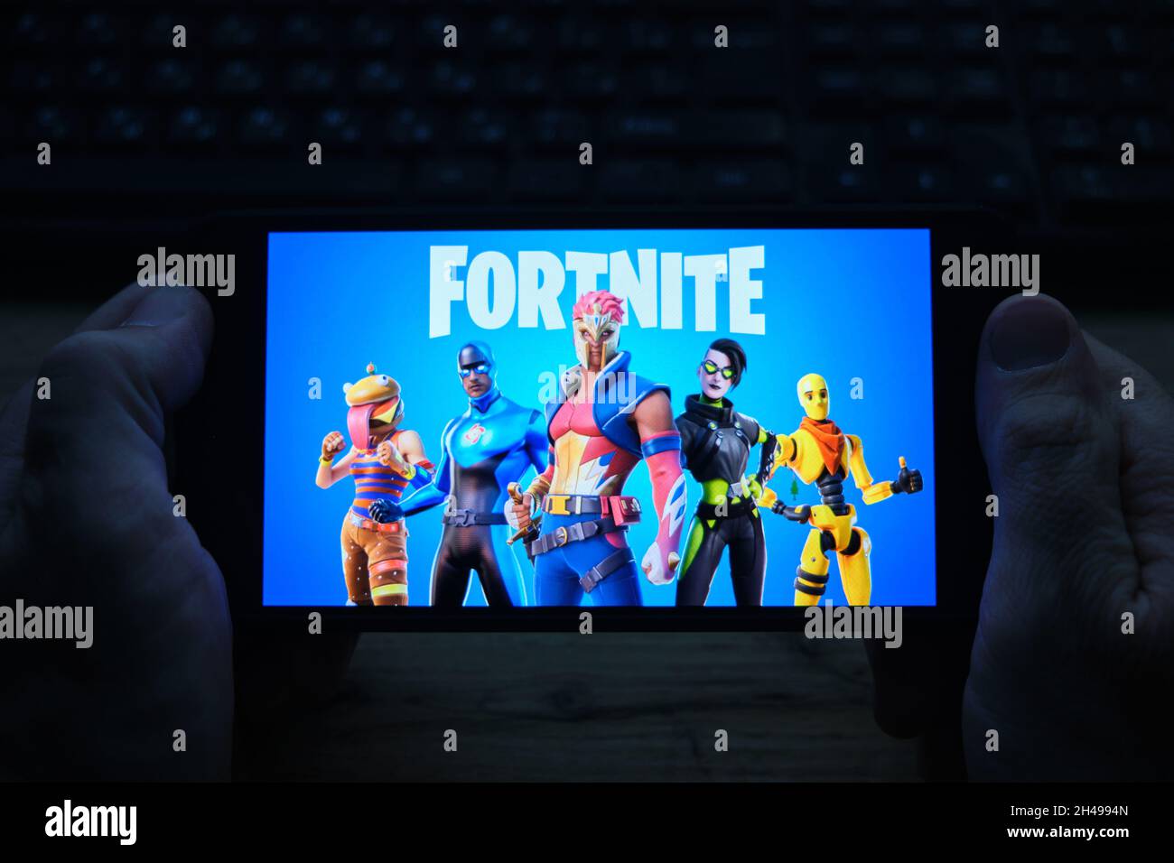 Kostanay, Kazakhstan, November 01, 2021.Man holding mobile phone with  screensaver of popular game Fortnite 2 from Epic Games Stock Photo - Alamy