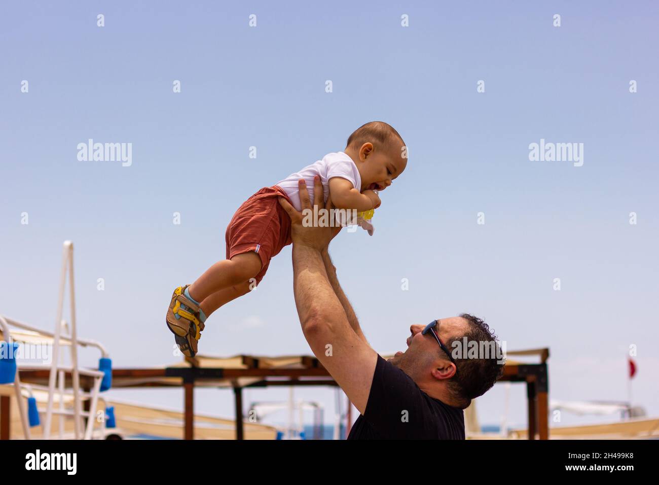 Father playing with child. Throwing baby up to air Stock Photo Alamy
