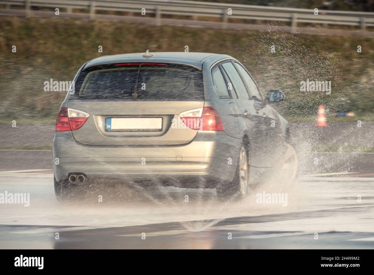 Car sliding on a wet professional training ground during a safe driving course Stock Photo