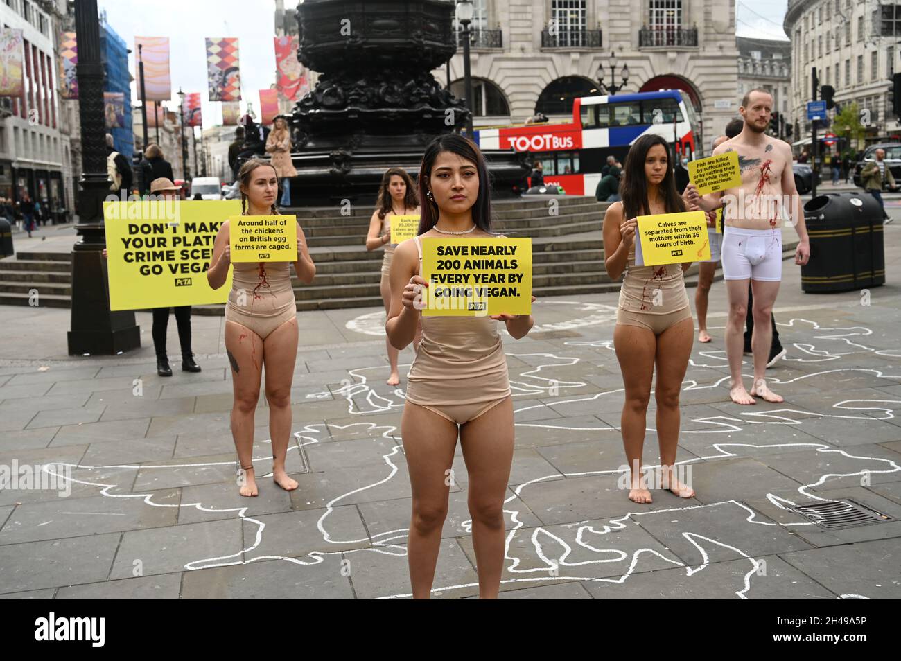 half nude world London, UK. 2021-11-01 Piccadilly Circus, London, UK. PETA nearly nude  animal rights group activists lie dead in meat Industry crime scene protest  on World Vegan Day in Piccadilly Circus, London. Credit: Picture