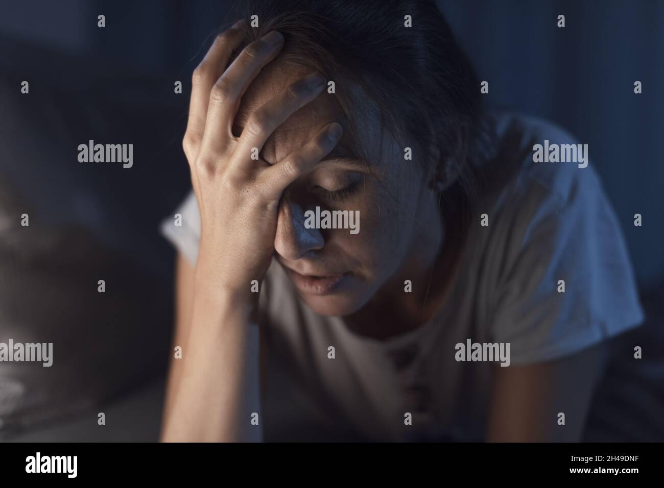 Desperate young woman awake late at night, she can't sleep and she has