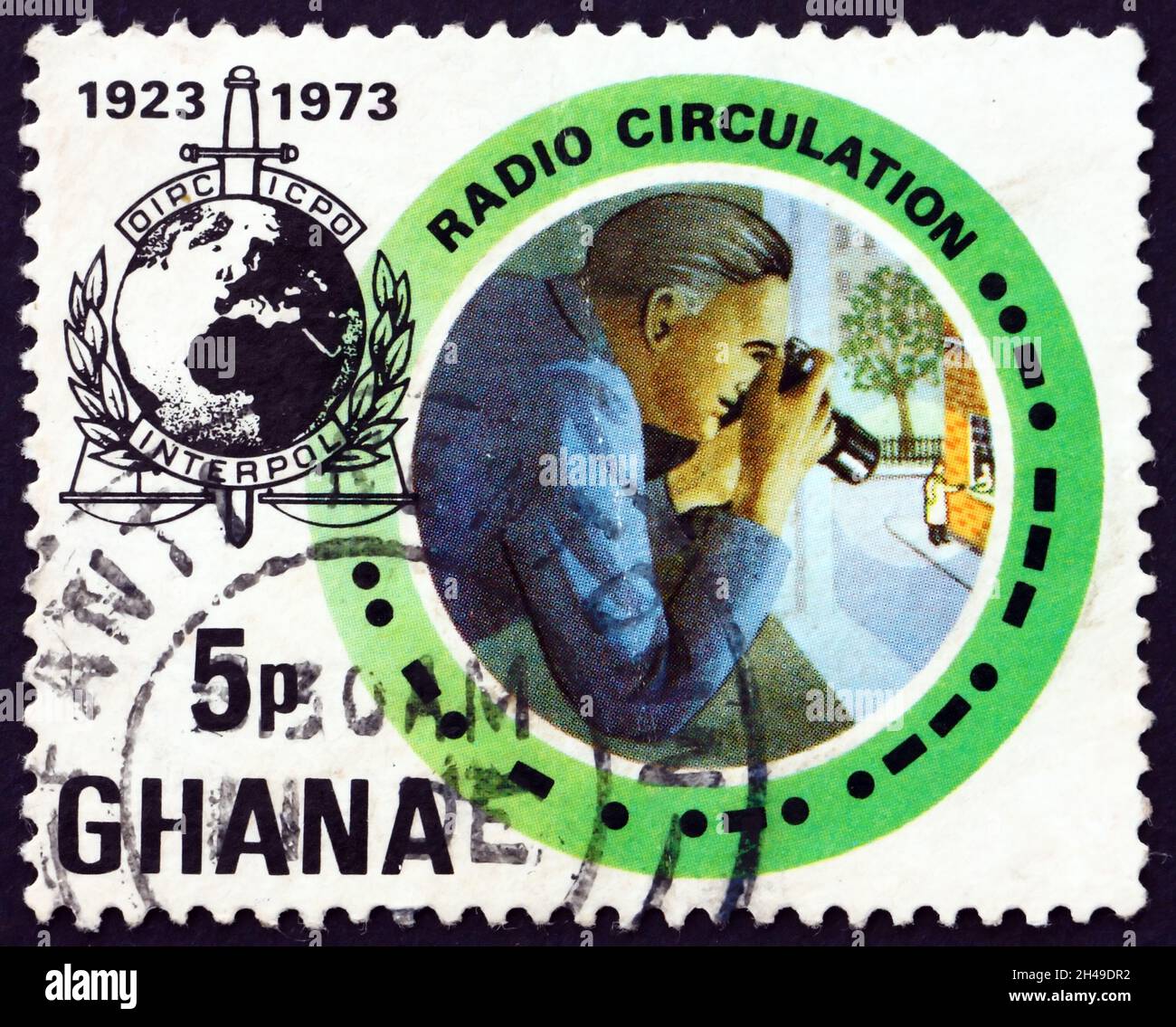 GHANA - CIRCA 1973: a stamp printed in Ghana shows INTERPOL emblem and observer, circa 1973 Stock Photo