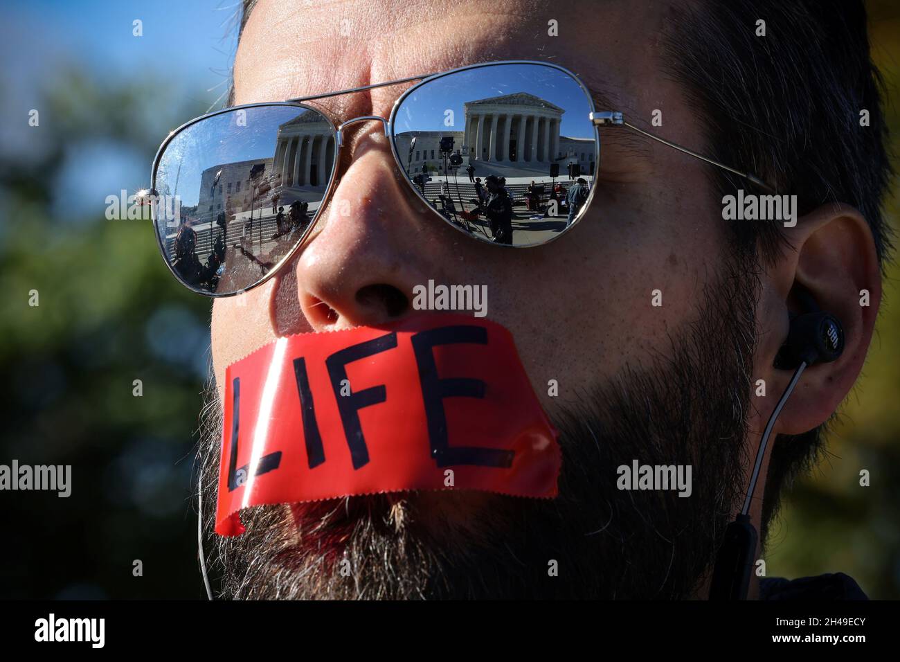 An anti-abortion demonstrator protests outside the United States Supreme Court as the court hears arguments over a challenge to a Texas law that bans abortion after six weeks in Washington, U.S., November 1, 2021. REUTERS/Evelyn Hockstein Stock Photo