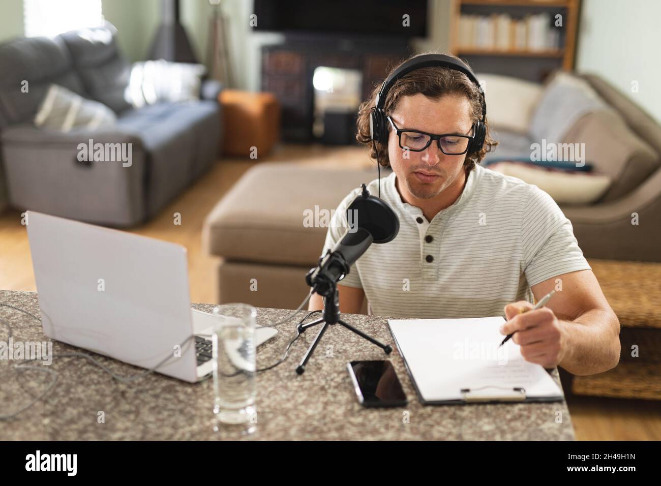 Caucasian disabled man recording podcast using microphone at home Stock