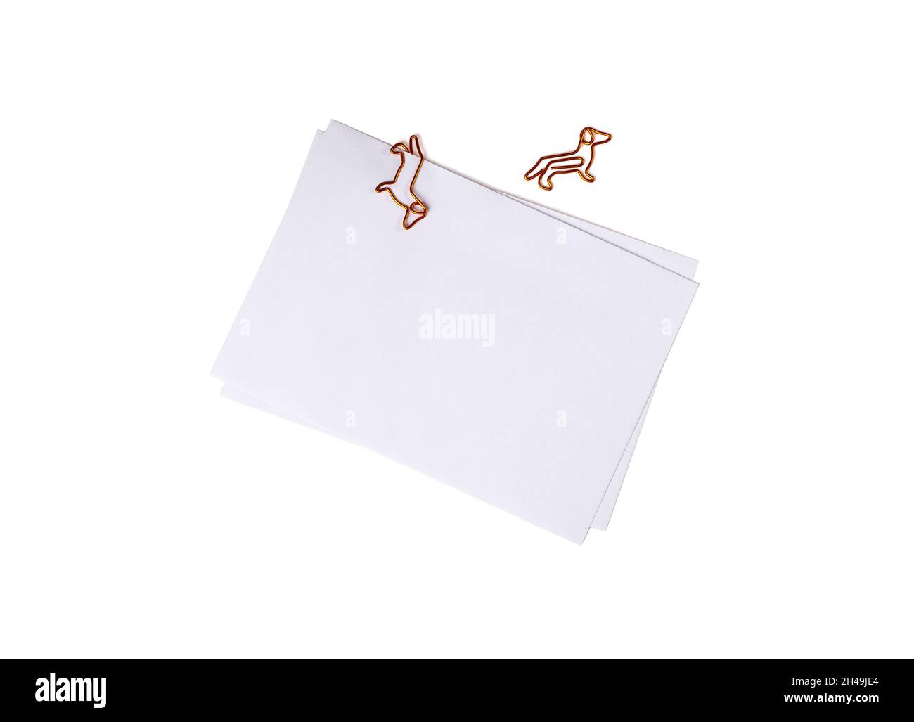 Paper envelope with dog-shaped paper clip on white background. Office supplies for a good mood. reminder on paper. Close up. congratulatory message Stock Photo
