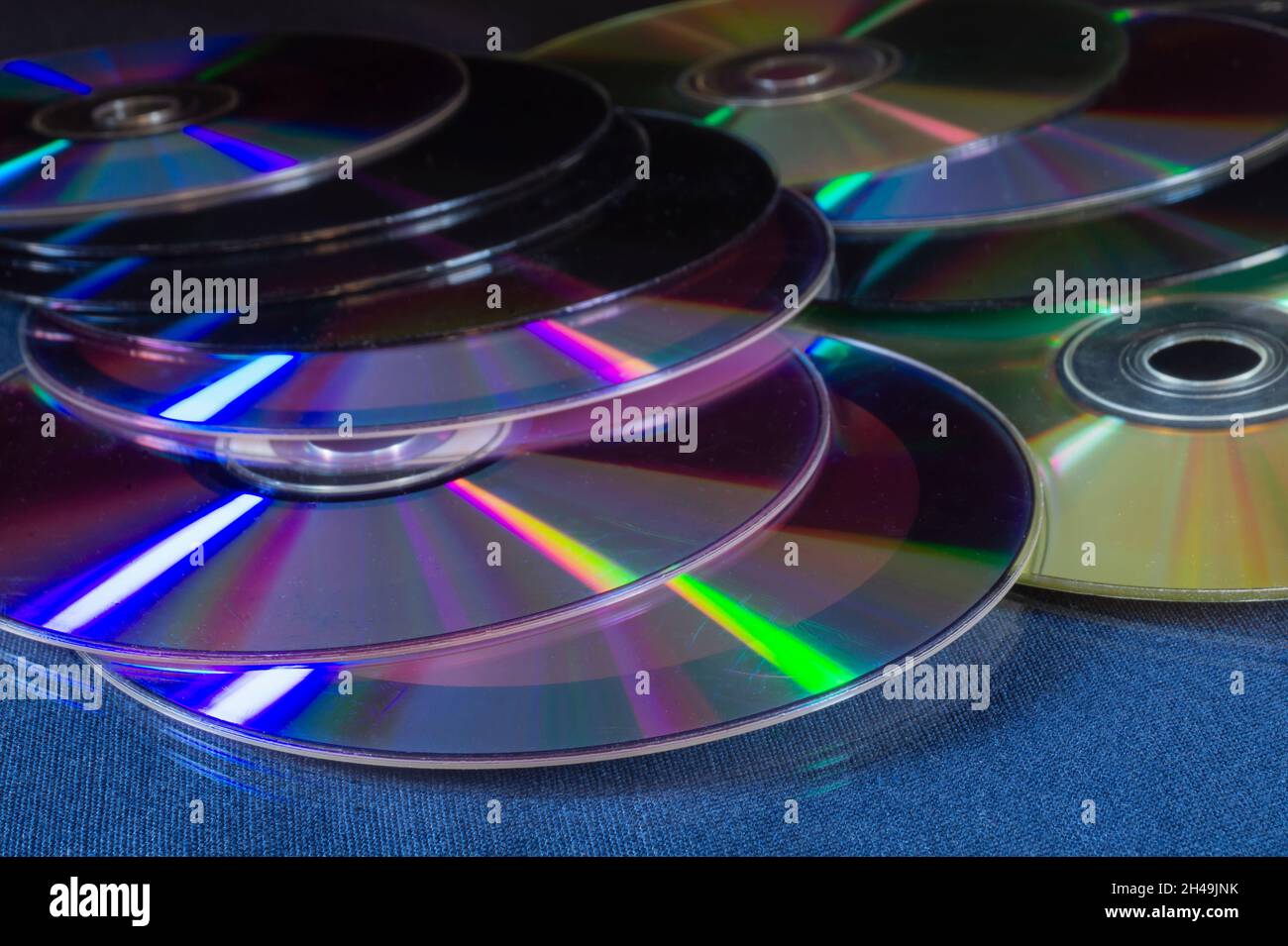 A stack of DVDs on a table with a reflection. Objects on a black background Stock Photo