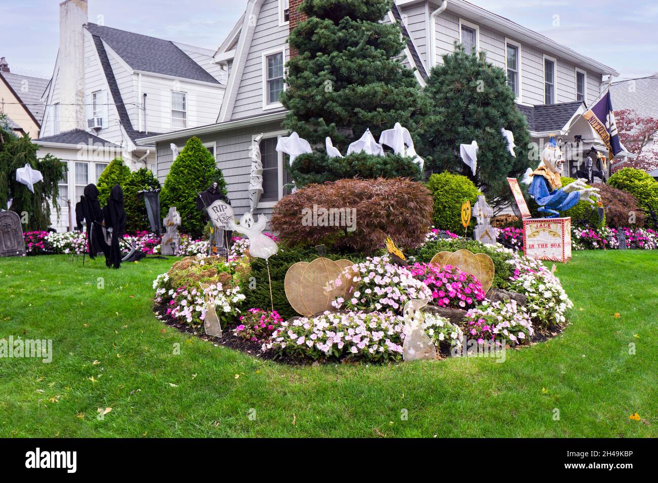 A house decorated elaborately for Halloween featuring colorful autumn flowers. In Queens, New York Stock Photo
