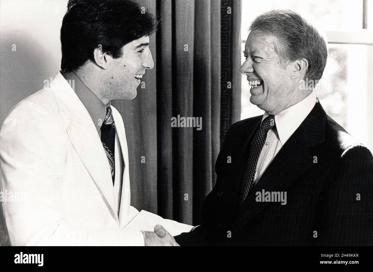 In the Oval Office President Jimmy Carter greets boxer Mike Rossman & congratulates him for bringing the light heavyweight championship back to the US. Stock Photo