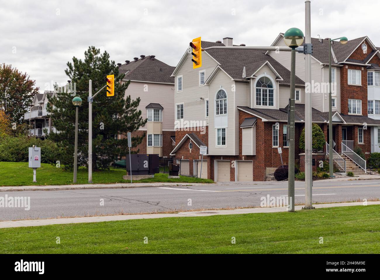 Street with houses and traffic lights at pedestrian crossing in Ottawa, Canada Stock Photo