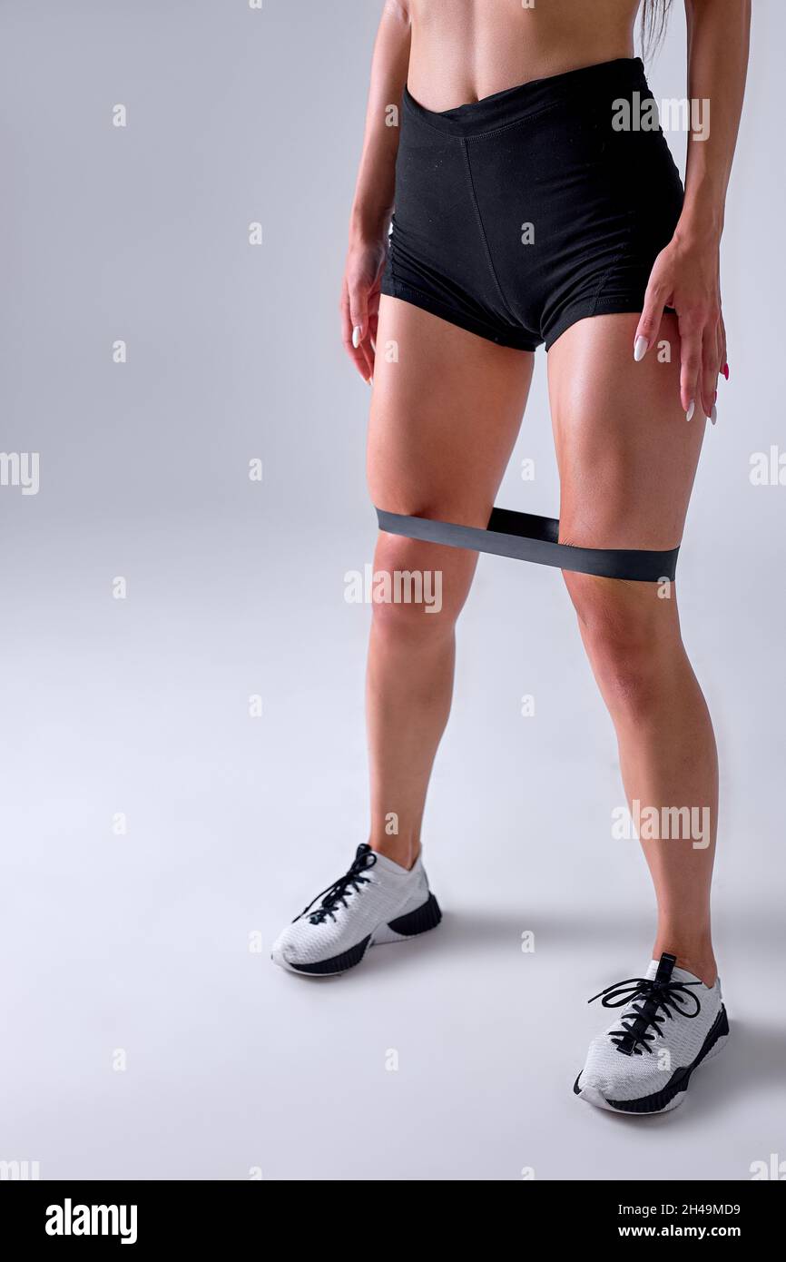 fit woman is doing leg workout using elastic Resistance band for fitness,  do exercises with strap elastic. Legs muscle activation. unrecognizable  spor Stock Photo - Alamy