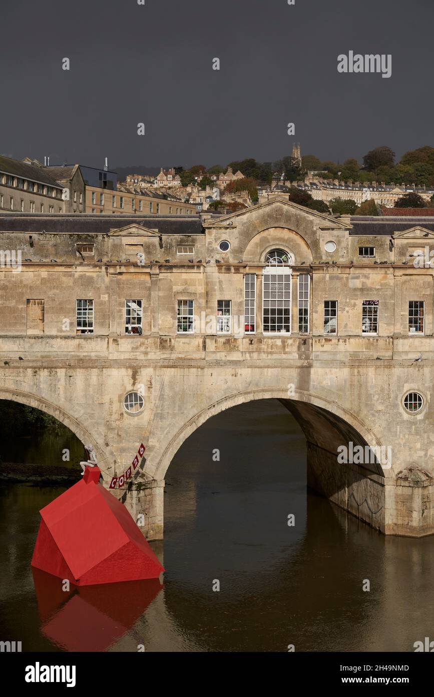Artwork marking COP26 comprising a red sinking house in the River Avon in the historic city of Bath in the United Kingdom Stock Photo