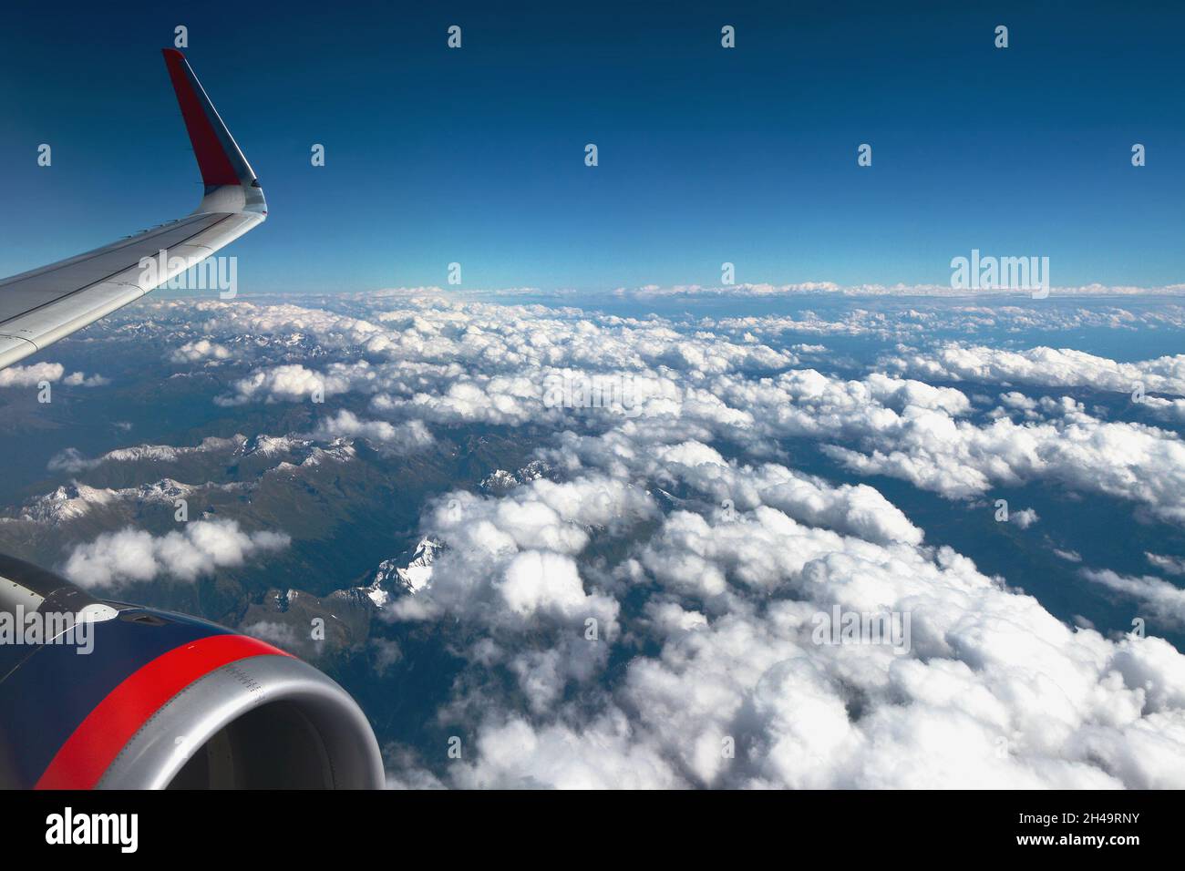 Under wing of aircraft are mountains and clouds. Caucasus, Krasnodar Territory, Russia Stock Photo