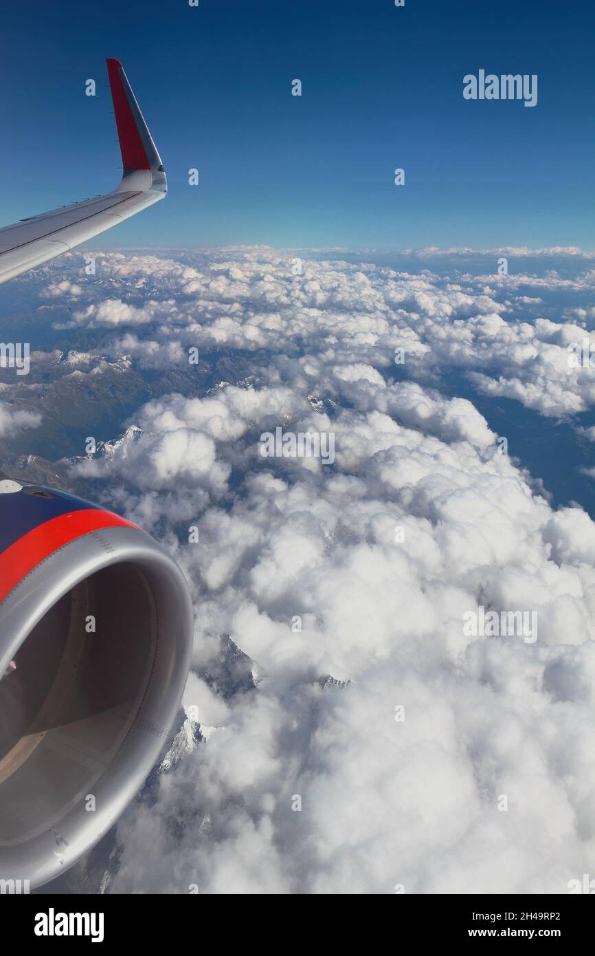 Under wing of aircraft are clouds and mountains. Caucasus, Krasnodar Territory, Russia Stock Photo