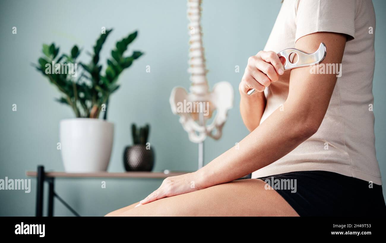 Instrument Assisted Soft Tissue Mobilisation self massage on arm Stock