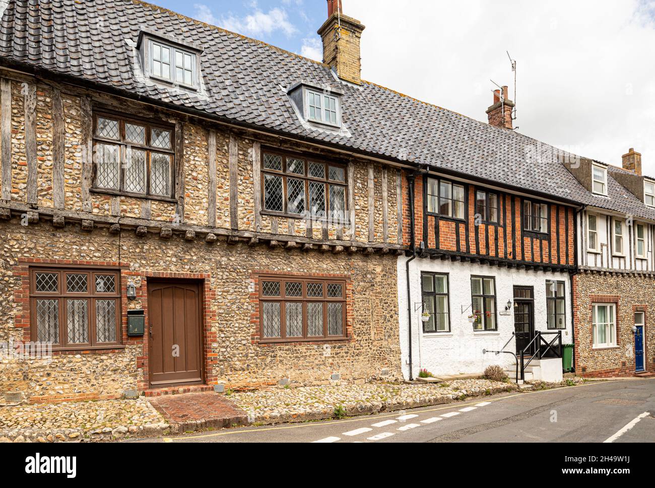 Old flint and half timbered, jettied buildings in the village of Little Walsingham, Norfolk UK. Stock Photo